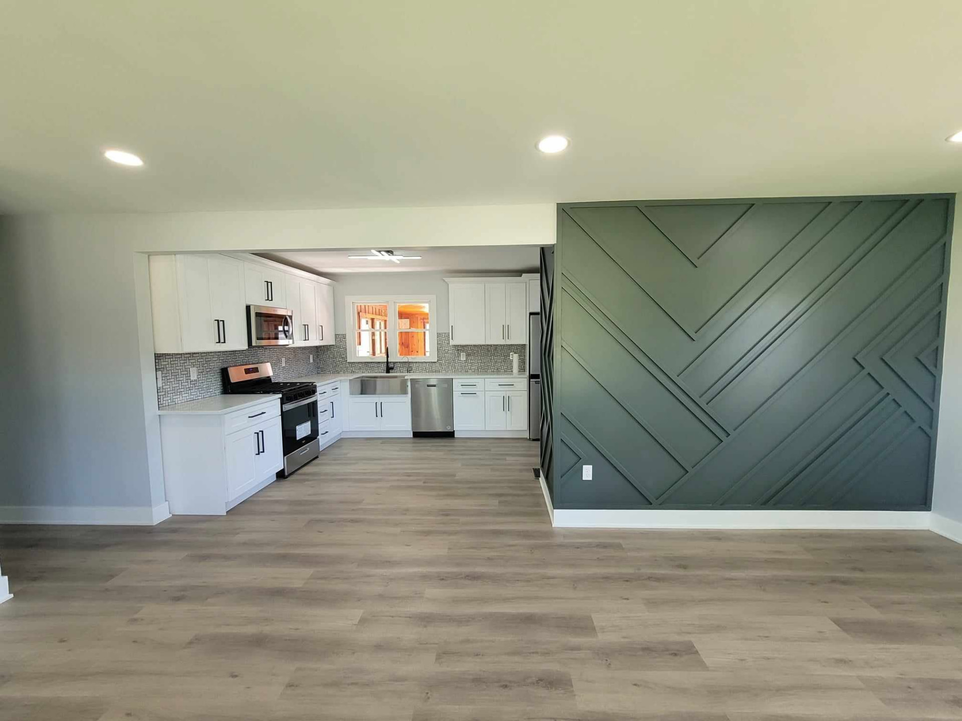Open-concept Mokena living room and kitchen with green geometric slat accent wall