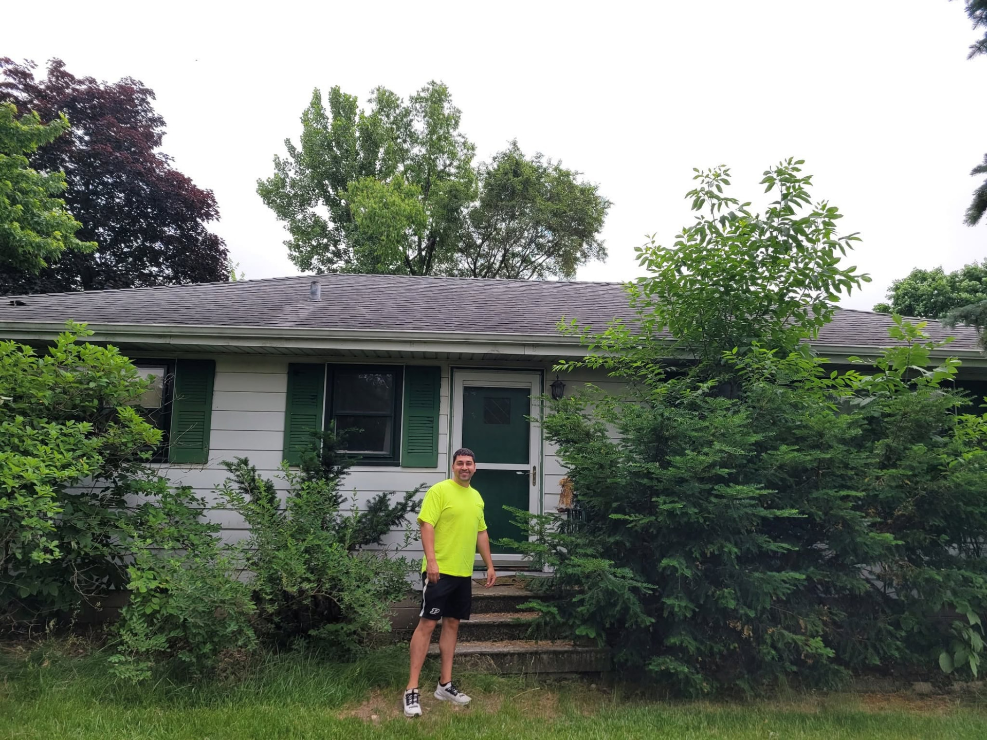 Before: overgrown shrubs and dated green shutters on the Mokena ranch exterior