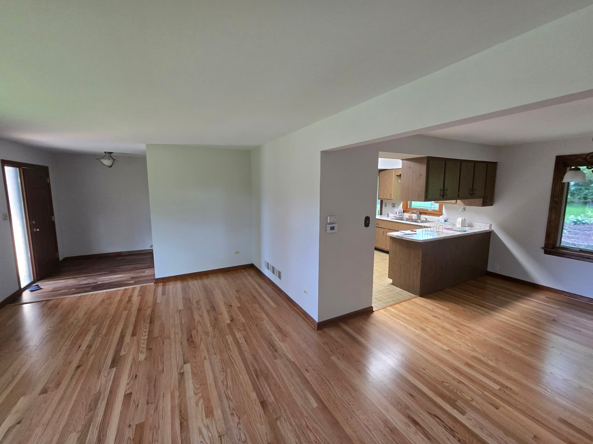 Before: original front living and dining rooms with the old layout and dated finishes