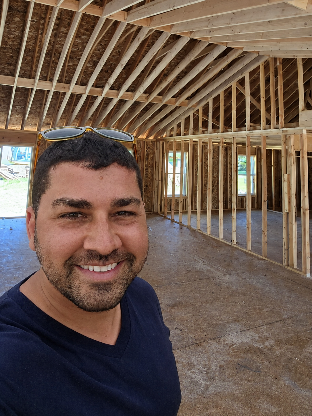 Adam Soyak, owner of One Stop RE Shop, on-site inside a newly framed home