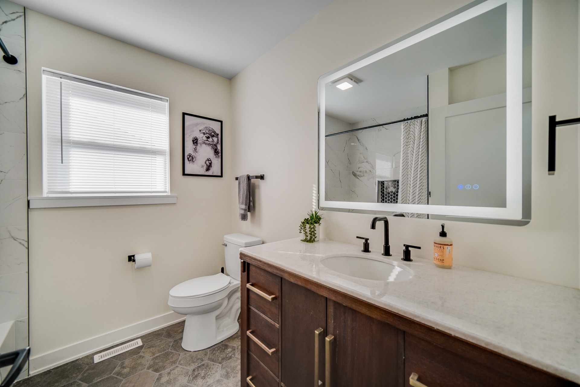 Full hall bathroom with quartz vanity and hex tile floor