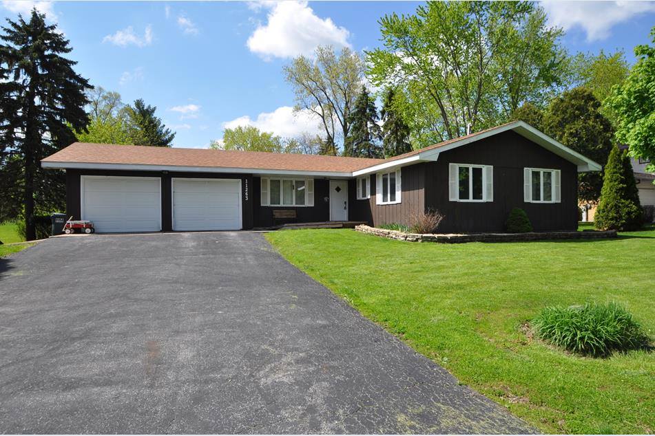 Before: dark brown board-and-batten ranch exterior with dated white shutters